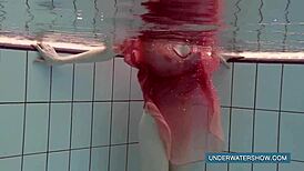 Katya Okuneva looks stunning in her red dress by the pool.