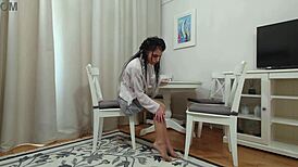 Kim Plays with Toys in Plaid Skirt and Nude Pantyhose, Showcasing Her Toned Legs