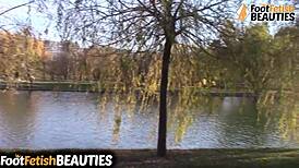 I see this brunette babe take off her socks and go barefoot in the park