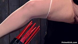 Redhead slave choked and gagged in strait jacket bondage.