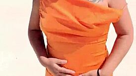 Wow, check out this horny Mexican slut flashing her thong and natural tits right on a public beach!