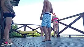 Leaked video of students recording orgy on dorm deck in red and sheer outfits.