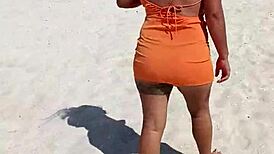 Wow, check out this horny Mexican slut flashing her thong and natural tits right on a public beach!