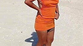 Wow, check out this horny Mexican slut flashing her thong and natural tits right on a public beach!