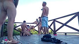 Leaked video of students recording orgy on dorm deck in red and sheer outfits.