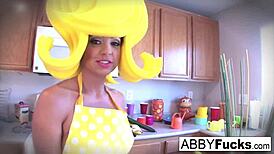 Surreal kitchen dress up scene with Abigail and her giant cucumber.