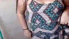 Amateur girl does striptease in bath, ripping clothes to show small tits.