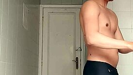 sexy guy shaving in black beach shorts