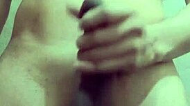 Hey, watch this shy guy masturbating his big cock in the bathroom