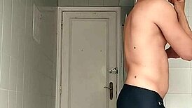 sexy guy shaving in black beach shorts