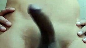 Hey, watch this shy guy masturbating his big cock in the bathroom