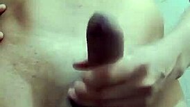 Hey, watch this shy guy masturbating his big cock in the bathroom