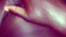 Teasing her hairy beaver with a monster black cock before penetration