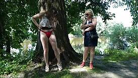 Two girls, a milf and a lady, stop by the road to indulge in golden rain.