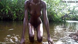 do you want to watch this skinny african girl bathing outdoors?