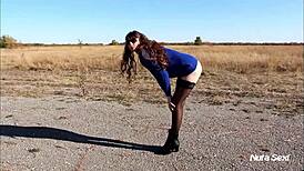 That leggy brunette is showing off her sexy body outdoors