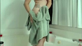 The chubby teen with a tight ass bathes in the shower on webcam.