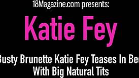 Busty brunette Katie Fey teases by undressing in bed, revealing her big natural tits.