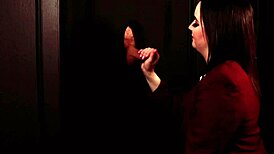 Student eagerly sucks cock through the gloryhole