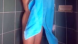 Lady rubs lotion on legs in shower!