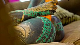 tattooed girl in fishnets and heels plays with toys solo