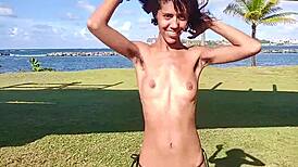 Skinny Latina teases flashing hairy pussy and small tits barefoot on public beach