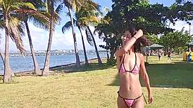 Skinny Latina teases flashing hairy pussy and small tits barefoot on public beach