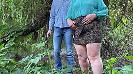 Chubby milf fingers fat pussy in woods then jerks massive cock to cum explosion outdoors