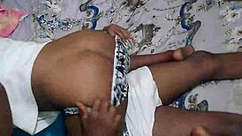 Curvy ebony girlfriend with big natural tits shakes ass while getting spanked in bedroom