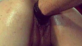 porno slut bends over as gloved fist stretches her pussy and ass wide open