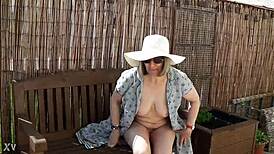 naughty housewife strips naked outdoors in lush garden surrounded by nature's wild beauty