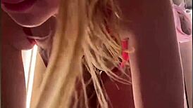 A horny teen fingers her tight pussy in public changing room